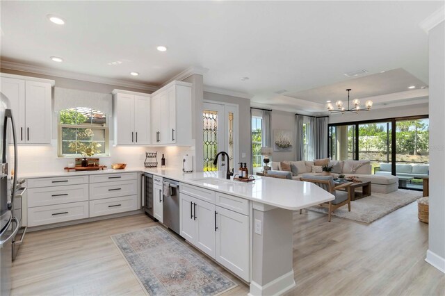 15752 Sacile Ln, Bradenton, FL 34211 - kitchen featuring a peninsula, a sink, dishwasher, open floor plan, and a chandelier