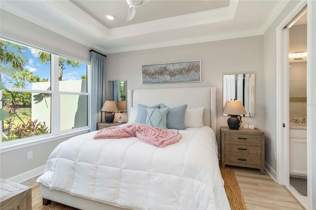 15752 Sacile Ln, Bradenton, FL 34211 - bedroom featuring a raised ceiling, light wood-style floors, ensuite bath, ornamental molding, and baseboards