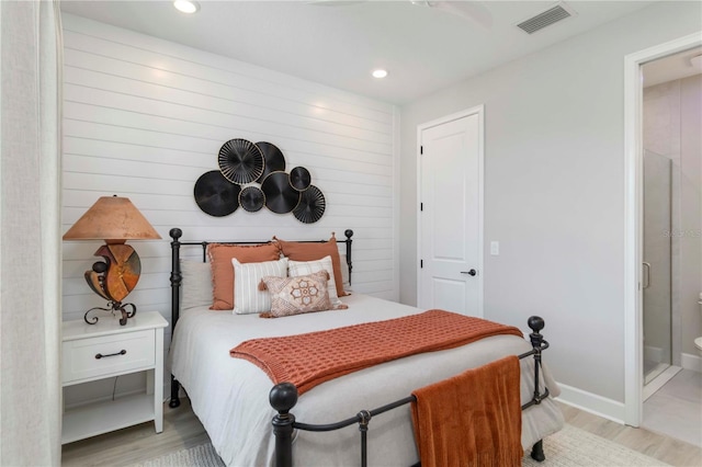 15752 Sacile Ln, Bradenton, FL 34211 - bedroom featuring light wood-style floors, recessed lighting, ensuite bathroom, and baseboards