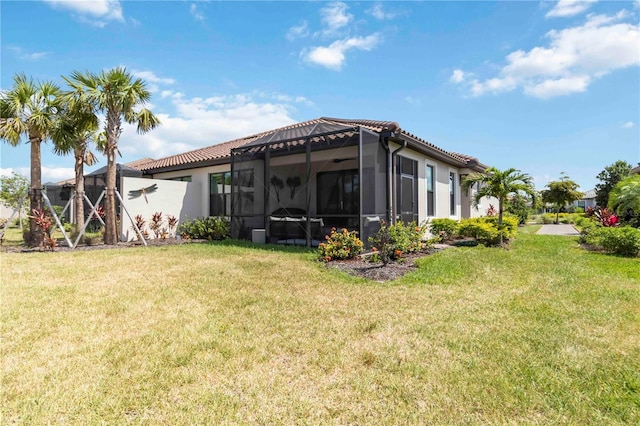 15752 Sacile Ln, Bradenton, FL 34211 - back of house with a lawn, glass enclosure, and a tile roof