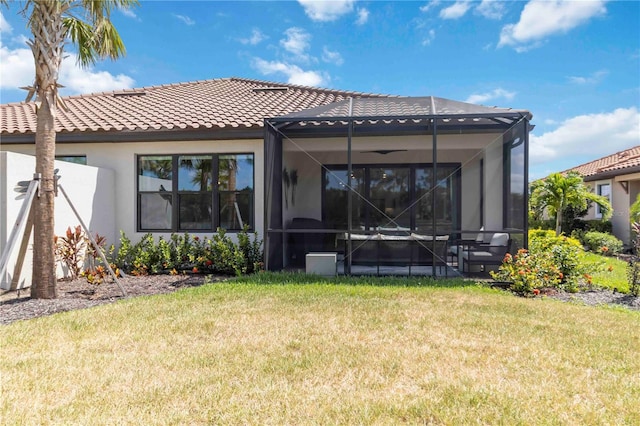 15752 Sacile Ln, Bradenton, FL 34211 - rear view of property with stucco siding, a lawn, and a tiled roof