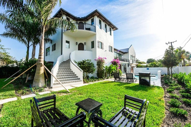 340 Jackson Dr, Sarasota, FL 34236 - back of property featuring stairs, a balcony, and stucco siding