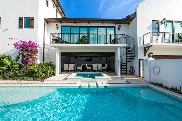 340 Jackson Dr, Sarasota, FL 34236 - rear view of property with a balcony, stairway, stucco siding, a pool with connected hot tub, and a patio area