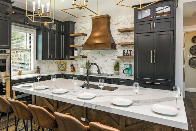 340 Jackson Dr, Sarasota, FL 34236 - kitchen featuring open shelves, premium range hood, tasteful backsplash, stainless steel double oven, and a sink