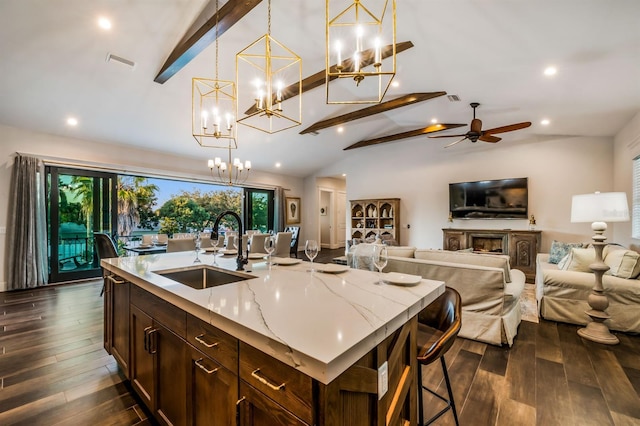 340 Jackson Dr, Sarasota, FL 34236 - kitchen featuring a sink, a chandelier, light stone counters, dark wood-type flooring, and recessed lighting