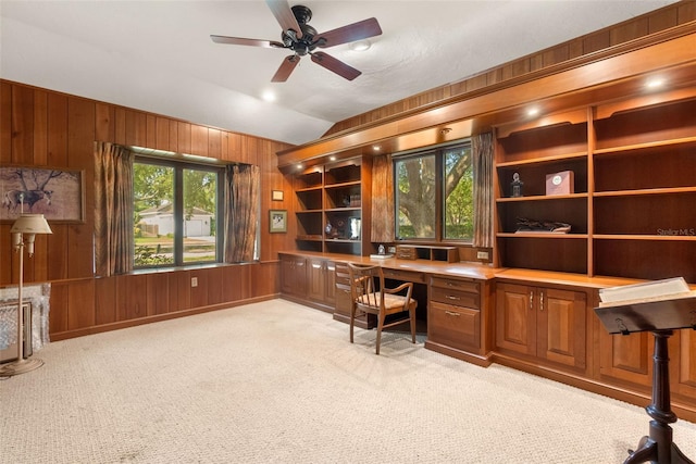 1671 S Dr, Sarasota, FL 34239 - unfurnished office featuring built in desk, light carpet, wooden walls, ceiling fan, and vaulted ceiling