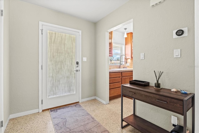 1324 Augusta Ln S, Saint Petersburg, FL 33707 - entryway featuring dark aggregate flooring, baseboards, and a textured wall