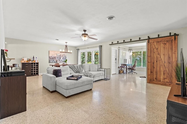 1324 Augusta Ln S, Saint Petersburg, FL 33707 - living room with speckled floor, healthy amount of natural light, ceiling fan, and a barn door