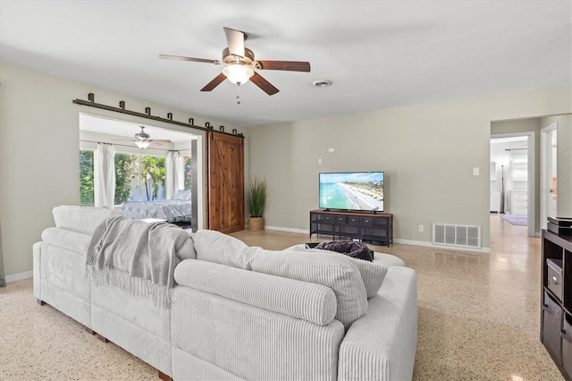 1324 Augusta Ln S, Saint Petersburg, FL 33707 - living area featuring dark speckled floor, a ceiling fan, and baseboards