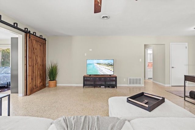 1324 Augusta Ln S, Saint Petersburg, FL 33707 - living area featuring speckled floor, a barn door, baseboards, and ceiling fan