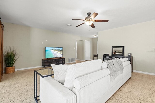1324 Augusta Ln S, Saint Petersburg, FL 33707 - living room with speckled floor, ceiling fan, and baseboards