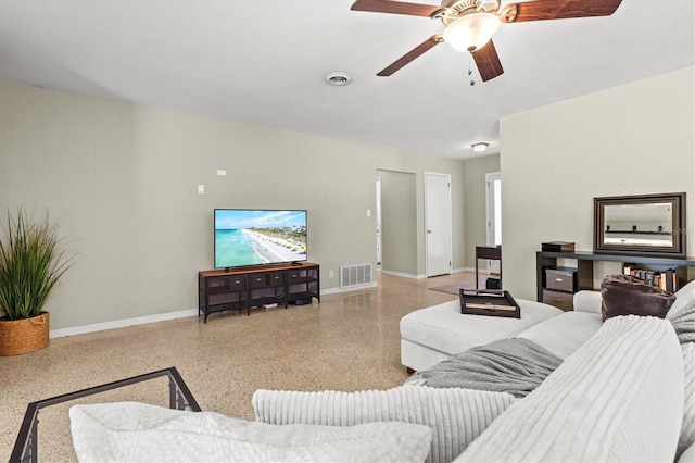 1324 Augusta Ln S, Saint Petersburg, FL 33707 - living room with speckle patterned floor, baseboards, and a ceiling fan