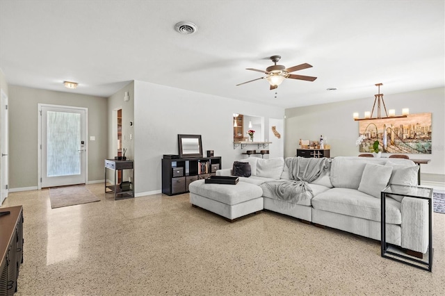 1324 Augusta Ln S, Saint Petersburg, FL 33707 - living room with ceiling fan, a chandelier, speckled floor, and baseboards