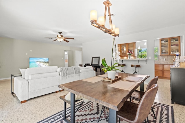 1324 Augusta Ln S, Saint Petersburg, FL 33707 - dining area featuring dark speckled floor, a ceiling fan, and baseboards