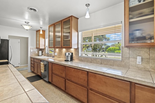 1324 Augusta Ln S, Saint Petersburg, FL 33707 - kitchen with a sink, healthy amount of natural light, appliances with stainless steel finishes, and tasteful backsplash