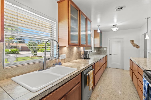 1324 Augusta Ln S, Saint Petersburg, FL 33707 - kitchen featuring a sink, stainless steel appliances, brown cabinets, and glass insert cabinets