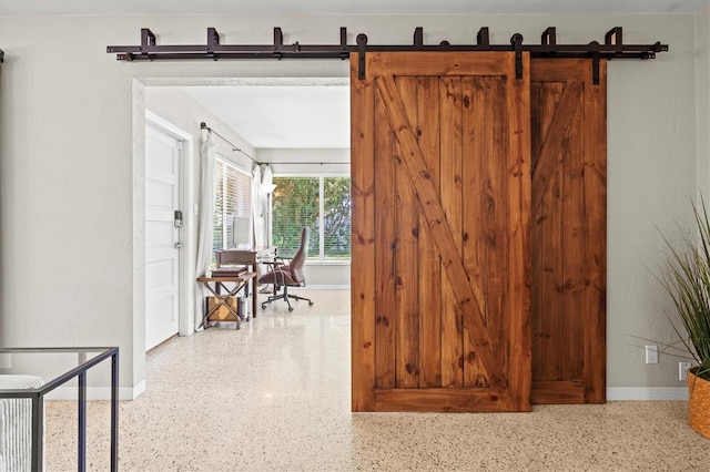 1324 Augusta Ln S, Saint Petersburg, FL 33707 - doorway to outside featuring speckled floor, baseboards, and a barn door