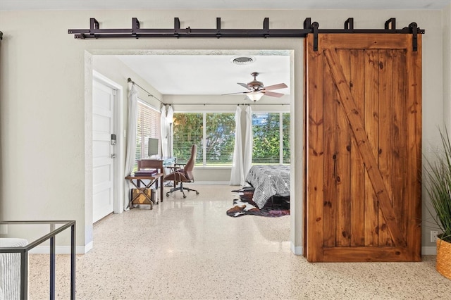 1324 Augusta Ln S, Saint Petersburg, FL 33707 - corridor featuring speckle patterned floor, baseboards, and a barn door