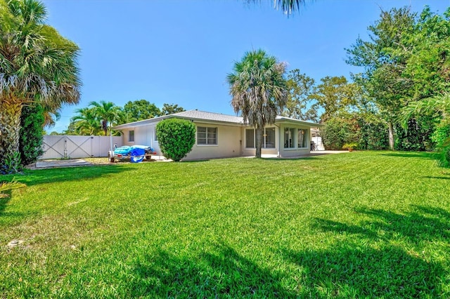 1324 Augusta Ln S, Saint Petersburg, FL 33707 - rear view of house with a gate and stucco siding