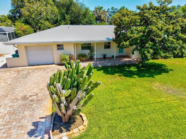 1324 Augusta Ln S, Saint Petersburg, FL 33707 - view of front of home with a garage, stucco siding, decorative driveway, and a front lawn