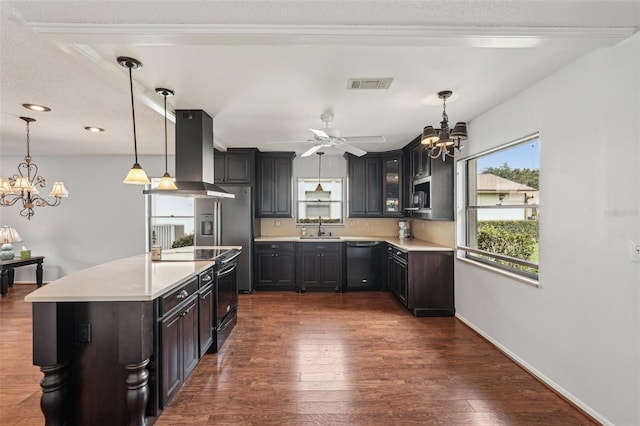 532 Oak Hill Cir Unit 12, Sarasota, FL 34232 - kitchen featuring island range hood, a chandelier, black appliances, light countertops, and a sink