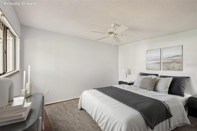 532 Oak Hill Cir Unit 12, Sarasota, FL 34232 - bedroom with a textured ceiling, a ceiling fan, and baseboards