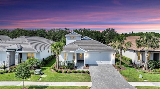 8069 Tidal Pointe Way, Sarasota, FL 34240 - ranch-style home featuring a garage, decorative driveway, a lawn, stucco siding, and a tiled roof