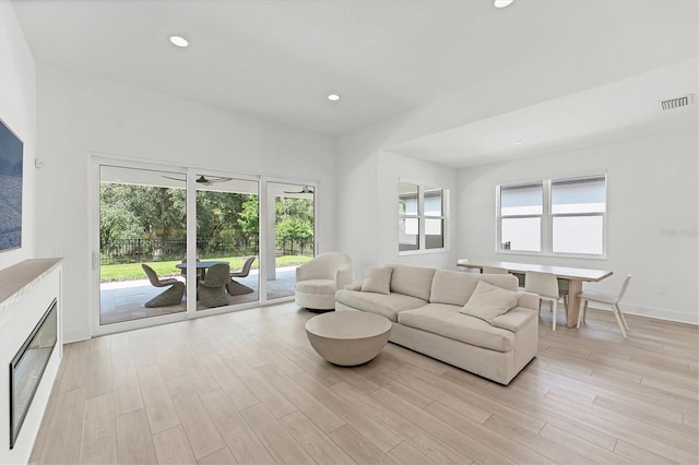 8069 Tidal Pointe Way, Sarasota, FL 34240 - living room with light wood finished floors, recessed lighting, and baseboards