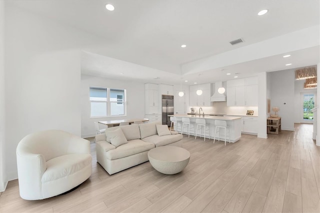8069 Tidal Pointe Way, Sarasota, FL 34240 - living room with light wood-style flooring, recessed lighting, and baseboards