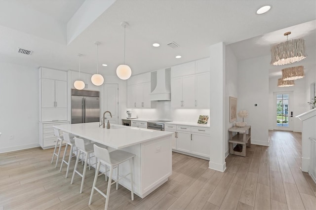 8069 Tidal Pointe Way, Sarasota, FL 34240 - kitchen featuring stainless steel built in refrigerator, premium range hood, a sink, light wood finished floors, and recessed lighting