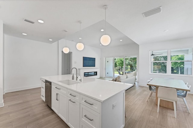 8069 Tidal Pointe Way, Sarasota, FL 34240 - kitchen with a sink, light wood finished floors, stainless steel dishwasher, light countertops, and recessed lighting