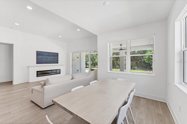 8069 Tidal Pointe Way, Sarasota, FL 34240 - dining area with plenty of natural light, light wood finished floors, baseboards, a glass covered fireplace, and recessed lighting