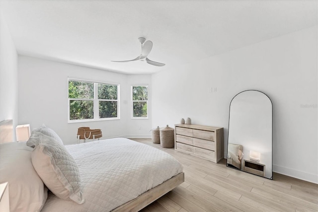 8069 Tidal Pointe Way, Sarasota, FL 34240 - bedroom featuring light wood-style flooring, a ceiling fan, and baseboards