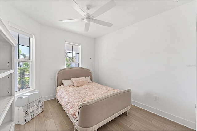 8069 Tidal Pointe Way, Sarasota, FL 34240 - bedroom with baseboards, wood finished floors, and a ceiling fan