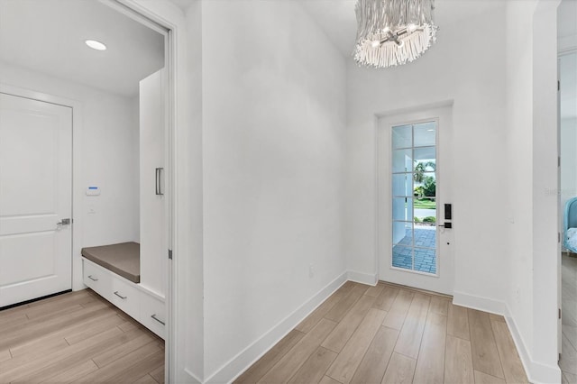 8069 Tidal Pointe Way, Sarasota, FL 34240 - foyer entrance with light wood-style flooring, baseboards, and a chandelier