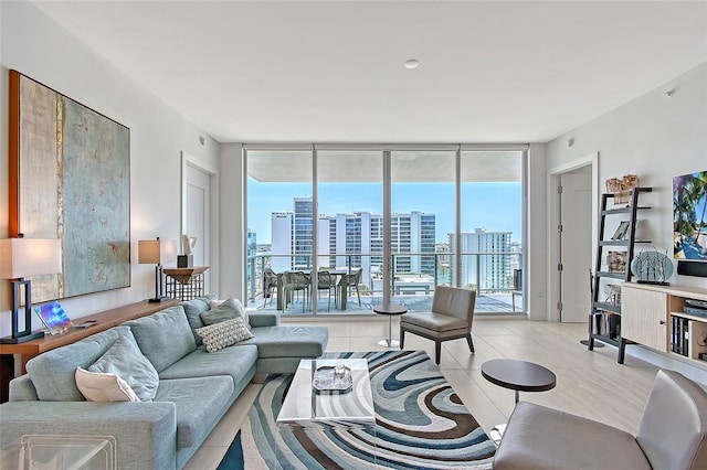 301 Quay Commons Unit 1208, Sarasota, FL 34236 - living area with healthy amount of natural light, a wall of windows, and light tile patterned floors