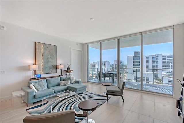 301 Quay Commons Unit 1208, Sarasota, FL 34236 - living room featuring expansive windows, a city view, light tile patterned floors, and baseboards