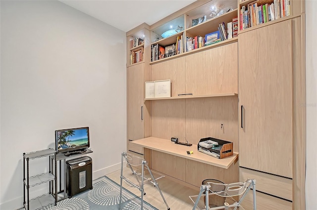 301 Quay Commons Unit 1208, Sarasota, FL 34236 - office space featuring baseboards, built in study area, and light wood finished floors