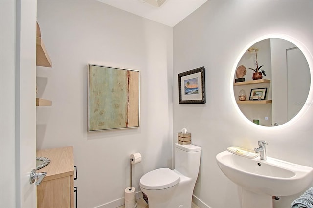 301 Quay Commons Unit 1208, Sarasota, FL 34236 - bathroom with baseboards, toilet, and a sink
