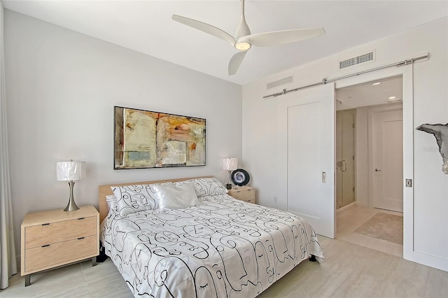 301 Quay Commons Unit 1208, Sarasota, FL 34236 - bedroom with a barn door and a ceiling fan