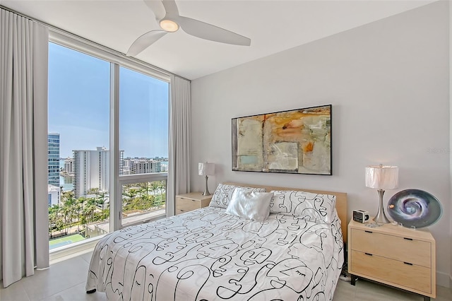 301 Quay Commons Unit 1208, Sarasota, FL 34236 - bedroom featuring a city view, tile patterned flooring, and ceiling fan