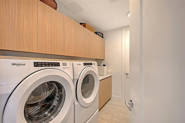 301 Quay Commons Unit 1208, Sarasota, FL 34236 - laundry room with washing machine and clothes dryer and cabinet space