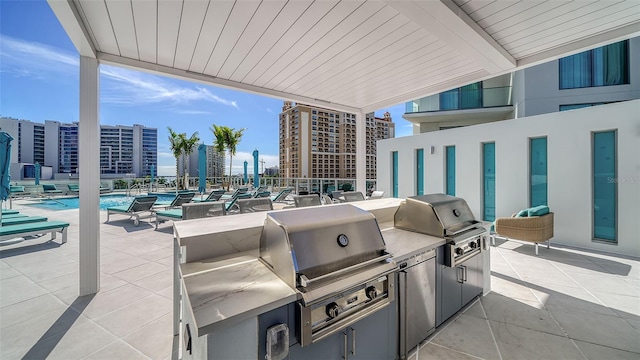 301 Quay Commons Unit 1208, Sarasota, FL 34236 - view of patio / terrace featuring a community pool and a city view