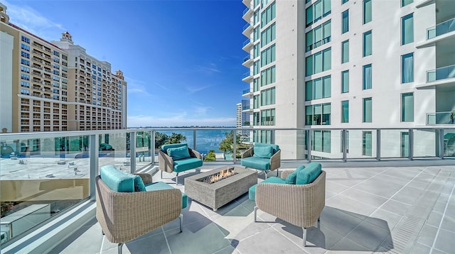 301 Quay Commons Unit 1208, Sarasota, FL 34236 - view of patio featuring an outdoor living space with a fire pit and a water view
