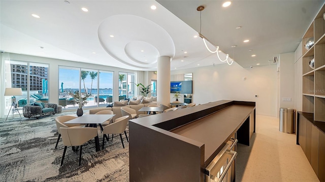 301 Quay Commons Unit 1208, Sarasota, FL 34236 - kitchen featuring light carpet, open floor plan, modern cabinets, recessed lighting, and a center island