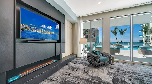 301 Quay Commons Unit 1208, Sarasota, FL 34236 - carpeted cinema room featuring a glass covered fireplace
