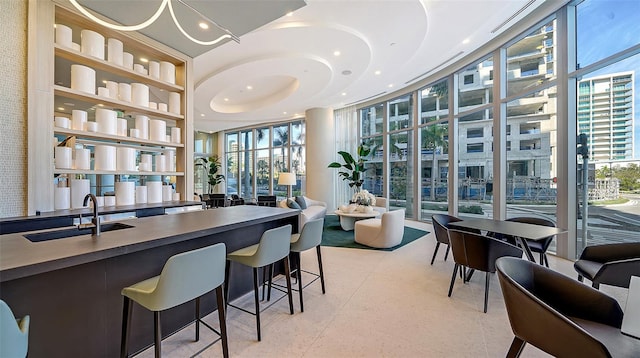 301 Quay Commons Unit 1208, Sarasota, FL 34236 - dining room featuring floor to ceiling windows, plenty of natural light, recessed lighting, and a high ceiling