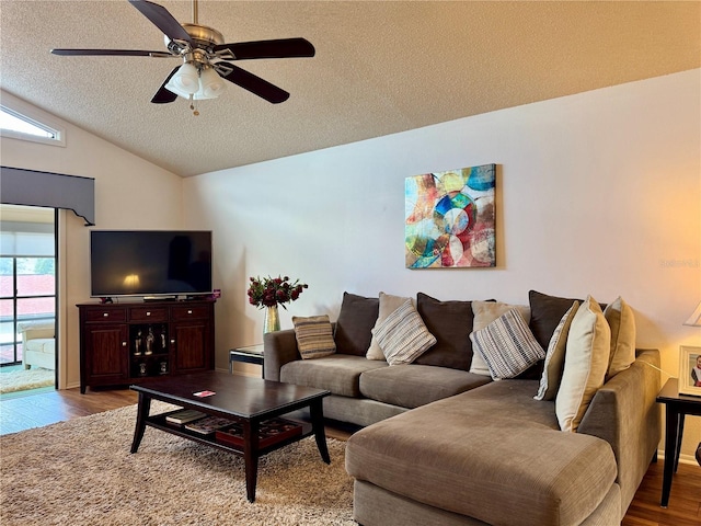 5400 34th St W Unit H12, Bradenton, FL 34210 - living room featuring light wood finished floors, a textured ceiling, healthy amount of natural light, ceiling fan, and lofted ceiling