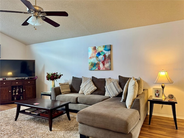 5400 34th St W Unit H12, Bradenton, FL 34210 - living area with light wood-style floors, ceiling fan, vaulted ceiling, and a textured ceiling