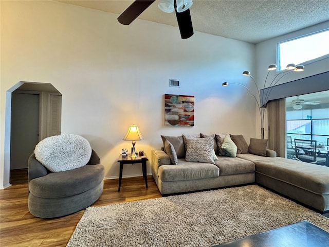 5400 34th St W Unit H12, Bradenton, FL 34210 - living area featuring a ceiling fan, healthy amount of natural light, arched walkways, and wood finished floors